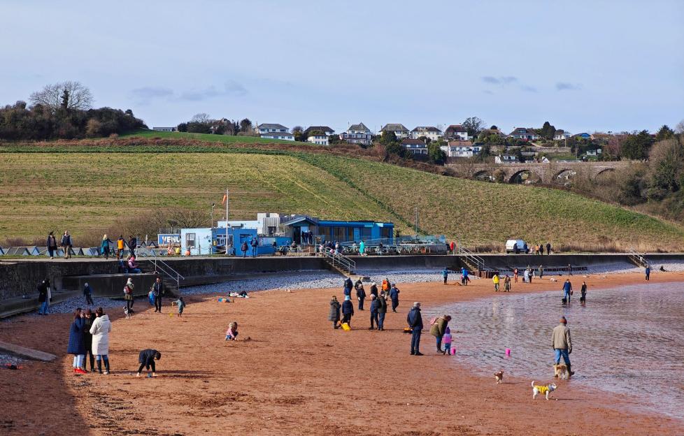 Broadsands, UK. 14 March 2026. People enjoying the winter sunshine on Broadsands Beach in Devon, with bright skies and mild seasonal weather drawing visitors to the coast.