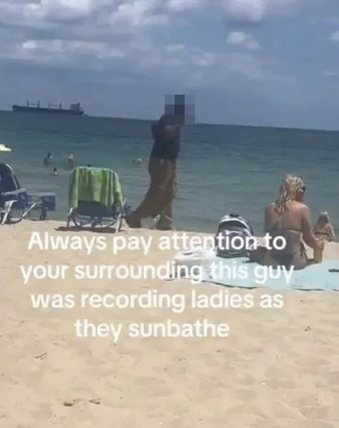 A man with a pixelated face walks on a beach near a woman sunbathing, with overlaid text warning others that he was recording women.