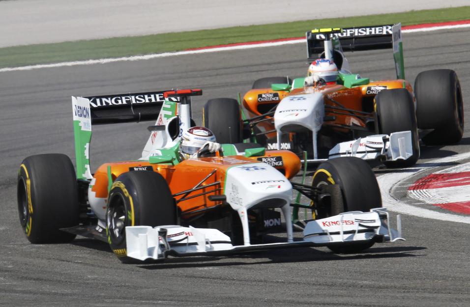 Adrian Sutil drives ahead of Paul di Resta in Force India Formula One cars at the Turkish F1 Grand Prix.