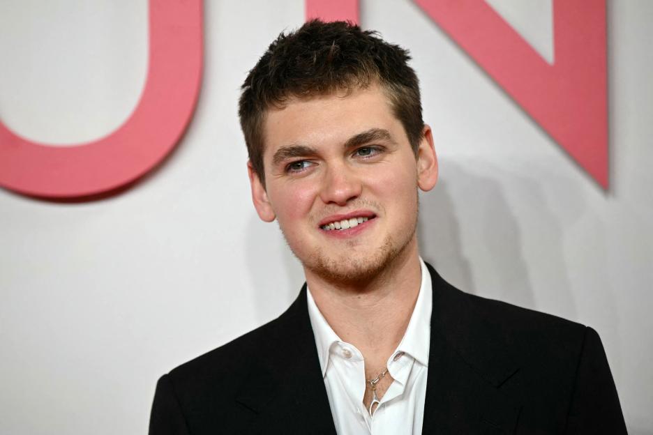 Actor and writer Joe Anders posing on the red carpet at a film premiere.