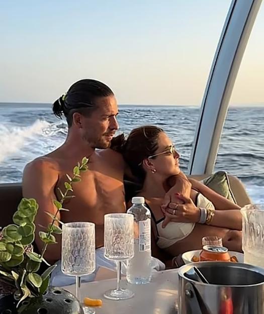 Sasha Attwood and Jack Grealish on a yacht at sea.