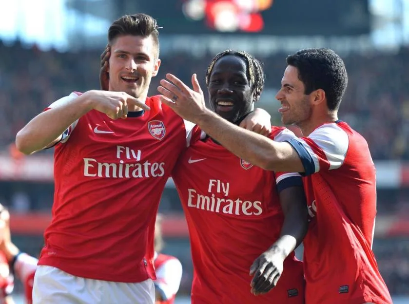 Olivier Giroud, Bacary Sagna, and Mikel Arteta of Arsenal celebrate a goal.