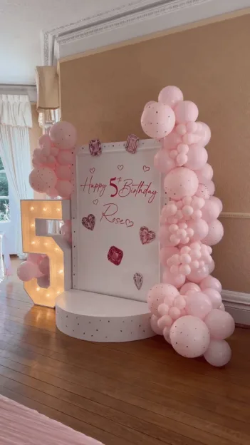 Stacey Solomon transformed her dining room for Belle's birthday with a white backdrop adorned with pink balloons and a giant light-up number five.