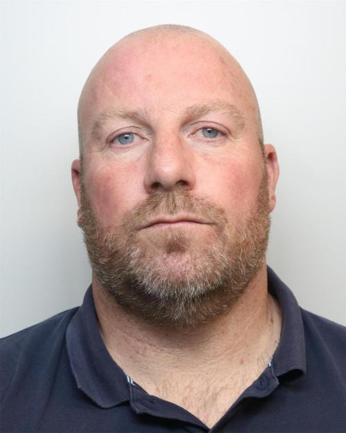 Simon Turner, a 49-year-old man with a bald head, beard, and blue eyes, who was jailed for romance fraud.