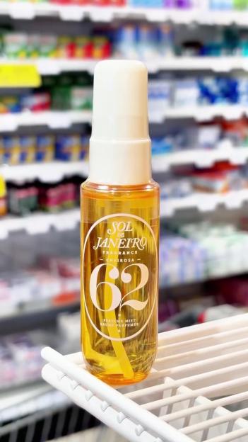 A bottle of Sol de Janeiro "Cheirosa '62" perfume mist on a store shelf.