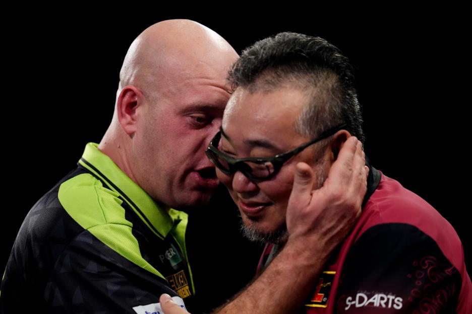 Michael van Gerwen speaking with Mitsuhiko Tatsunami after winning their match at the Paddy Power World Darts Championship.