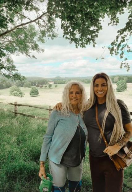 Katie Price smiling with her mother, Amy Price, outdoors.