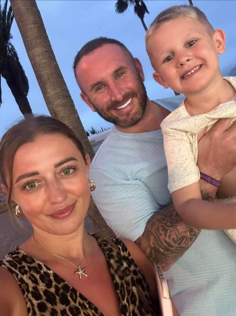 James Bainbridge, his partner Jessica Hill, and their son Alfie smiling for a photo.