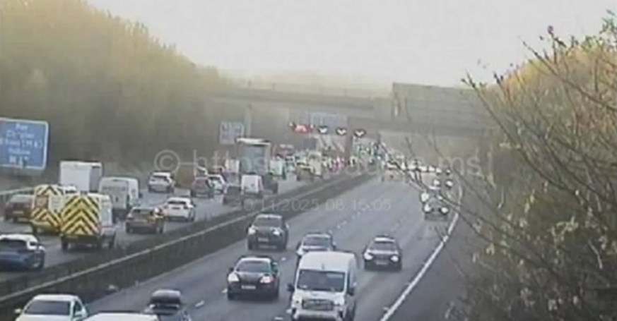 CCTV image showing heavy traffic on a multi-lane motorway with cars backed up due to an incident ahead.