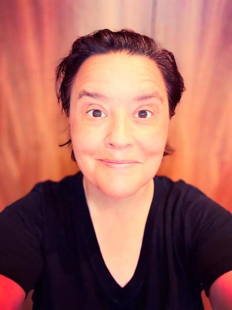 Woman with short dark hair in a black t-shirt.