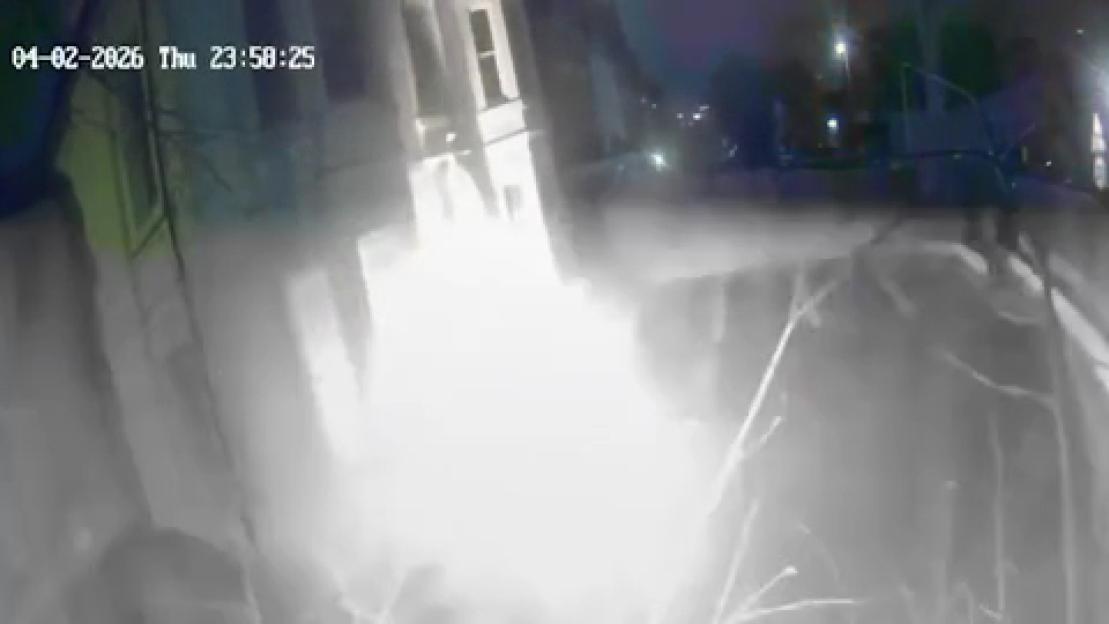 CCTV footage showing a bright flash of an explosion from a petrol bomb thrown at a building.
