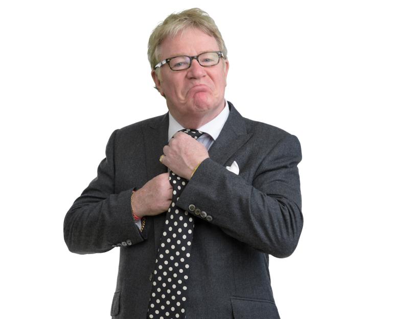Comedian Jim Davidson adjusting his tie.