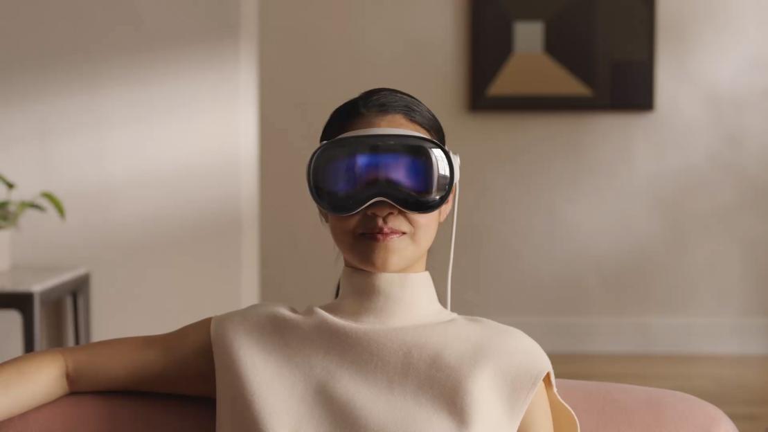 A woman wearing an Apple Vision Pro headset.
