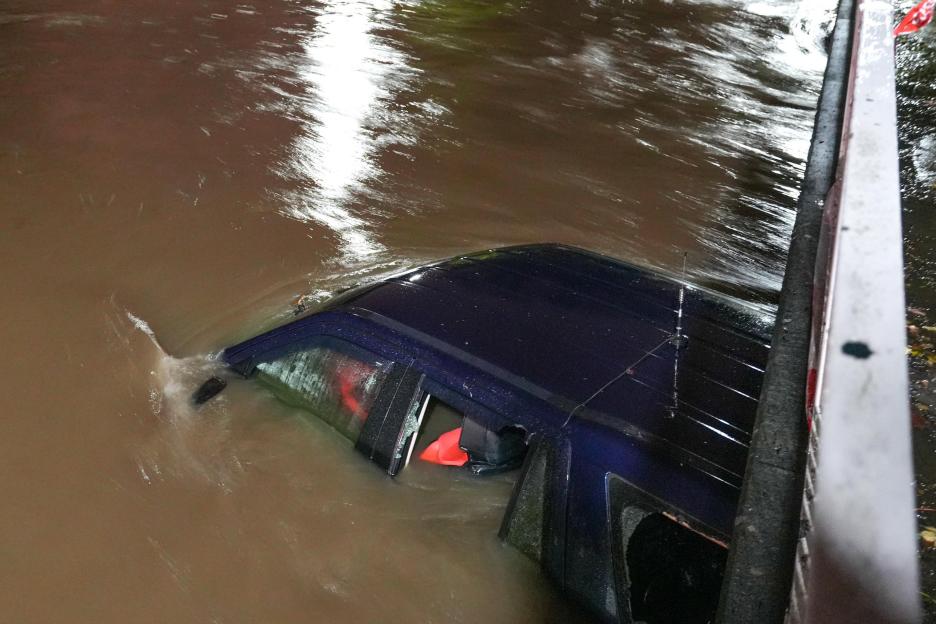Green Road, Birmingham, Nov 14th 2025 - A 4x4 has been abandoned after the driver risked navigating a flooded ford in the Hall Green area of Birmingham on Friday night. Smashed windows could be seen suggesting the occupants were unable to open the do