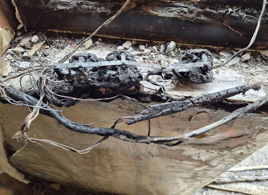 Melted electrical wires and burnt remains from a house fire.