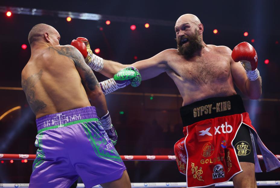 Tyson Fury lands a punch on Oleksandr Usyk during their boxing match.