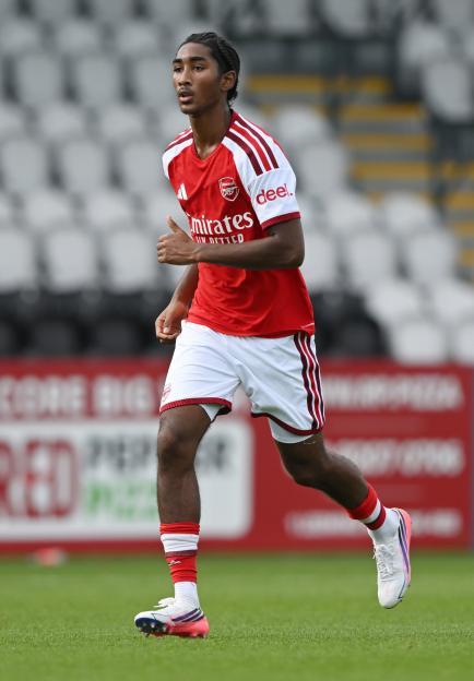Arsenal U21 player running in a red and white uniform.