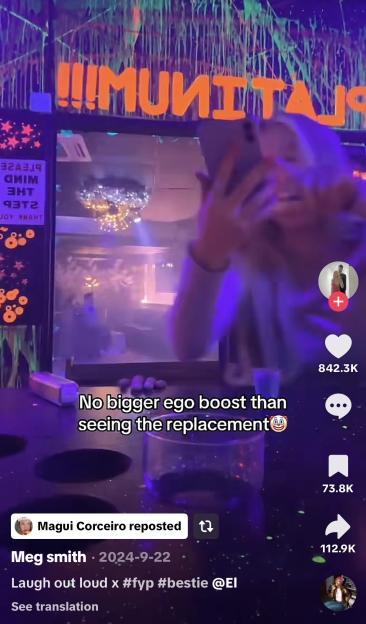 A woman taking a mirror selfie in a neon-lit room with text overlay that reads "No bigger ego boost than seeing the replacement".