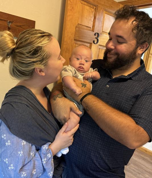 Parents Megan Popps and Devaughn Debelak with their son, Leo Debelak.