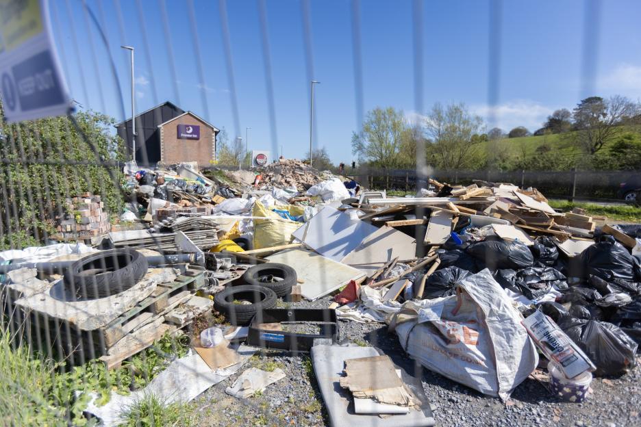 Dumped rubbish on Morland Road in Glastonbury, with a Premier Inn visible in the background.