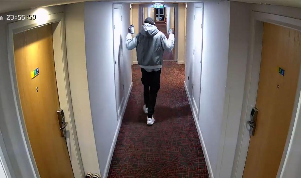 CCTV footage of Deng Majek walking down a hotel corridor.