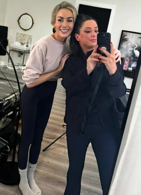 Two women posing for a selfie in front of a mirror.