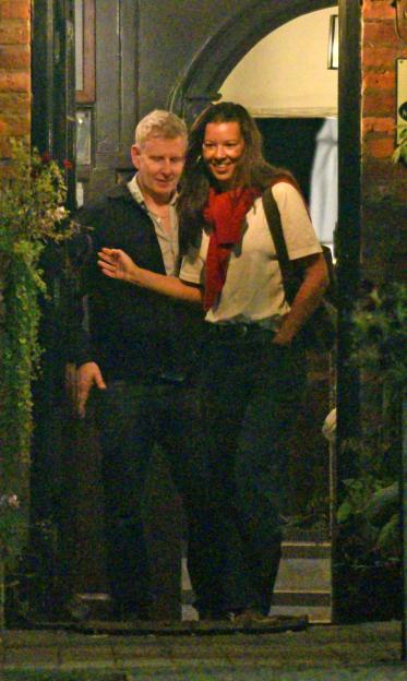 TV presenter Patrick Kielty smiling while leaving a north London pub with a tall brunette woman.