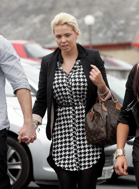 Rachael Martin arrives at Truro Crown Court, holding hands with a man, to be sentenced for theft.