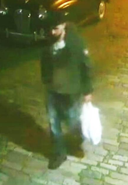 Suspect carrying a white plastic shopping bag