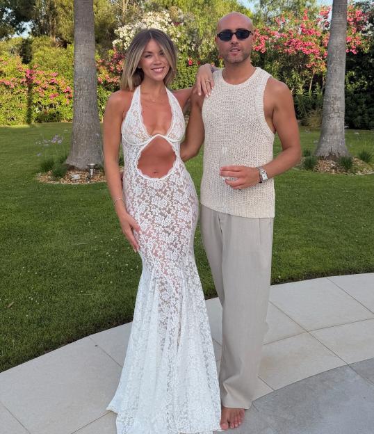 Holly Shearer at a hen-do, posing in a garden with a man.