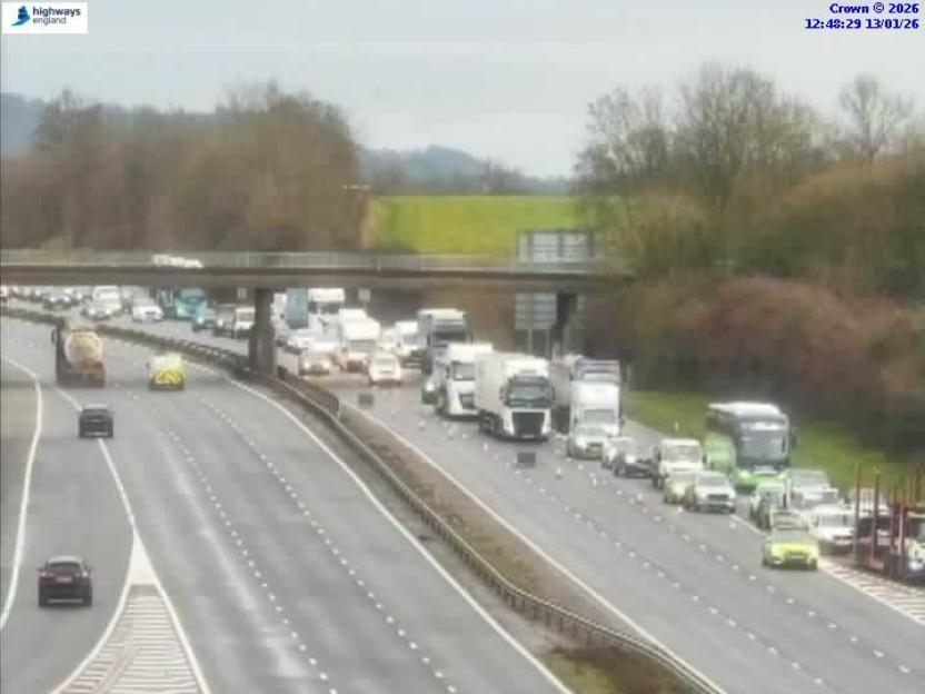 Traffic jam with cars and trucks on a highway.