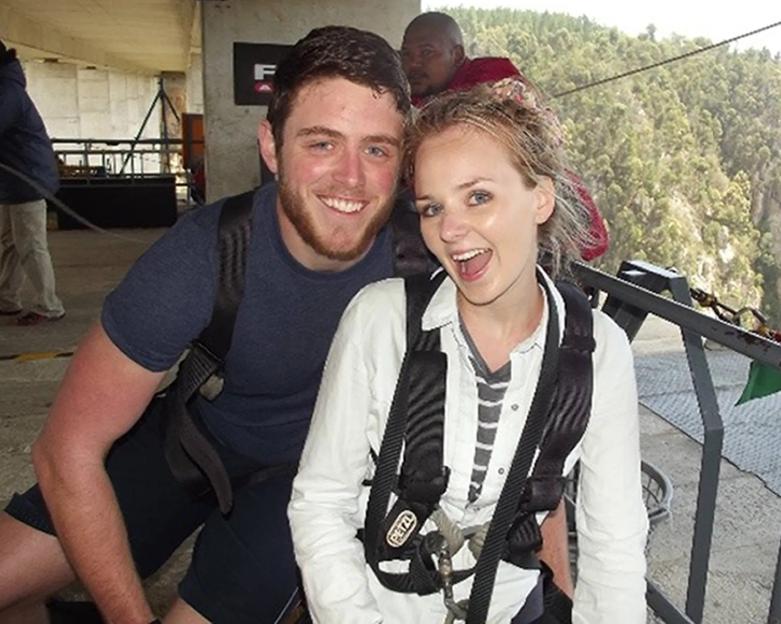Police constable Andrew Harper and his wife Lissie, wearing harnesses and smiling.
