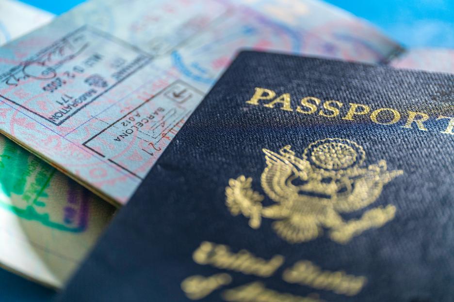 Close-up of an American passport with several visa stamps visible.