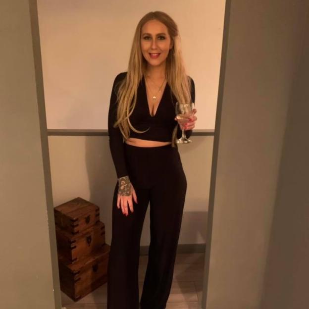 April Charlesworth holding a glass of wine before an accident involving an exploding portable heater.