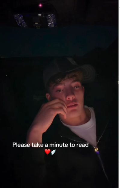 A young man in a cap, wearing a black jacket over a white shirt, with text "Please take a minute to read" and emojis of a red heart and white wings.