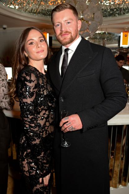 Holly Ramsay and Adam Peaty pose inside the GQ Men of the Year event.