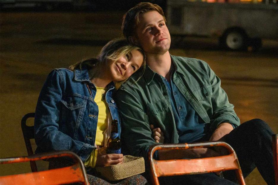 a man and a woman are sitting next to each other on a bench