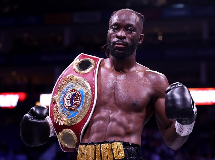 Dereck Chisora with a championship belt on his shoulder.