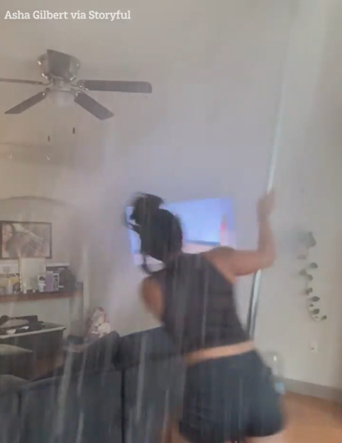 A person pole-dancing accidentally hits a ceiling sprinkler, causing water to spray everywhere.
