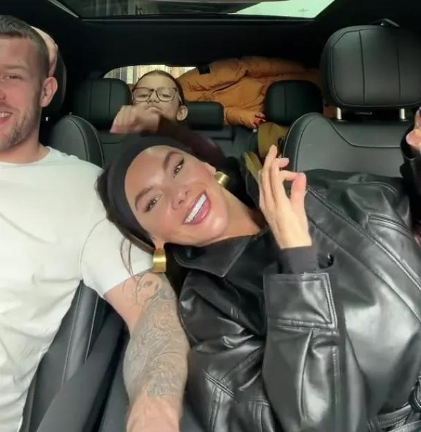 Chelsee Healey in the passenger seat of a car with two other people.