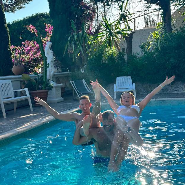 Three people, including Emily Atack, playing in a swimming pool during a hen do.