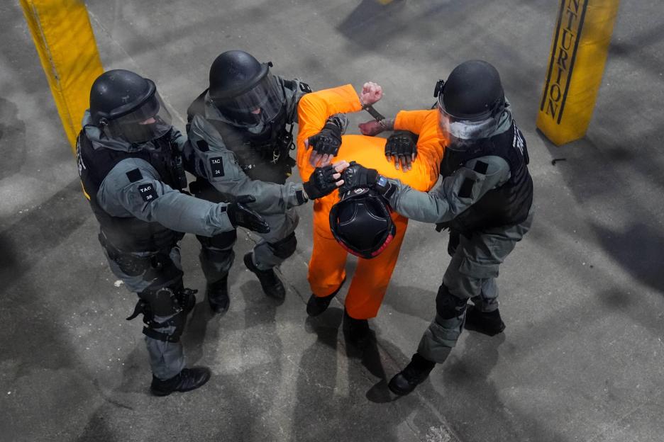 Officers restrain a prisoner during a demonstration showing potential high-risk scenarios for prison officers, during the launch of a taser trial in the adult male prison estate at the Operational Response & Resilience Unit (ORRU) training site in Ki