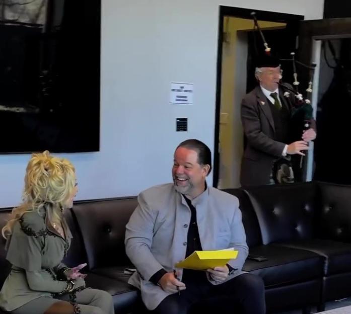 Dolly Parton celebrating her 80th birthday with a bagpiper sent by U2.