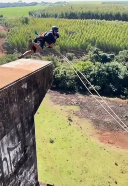 A person bungee jumping off a tall structure.