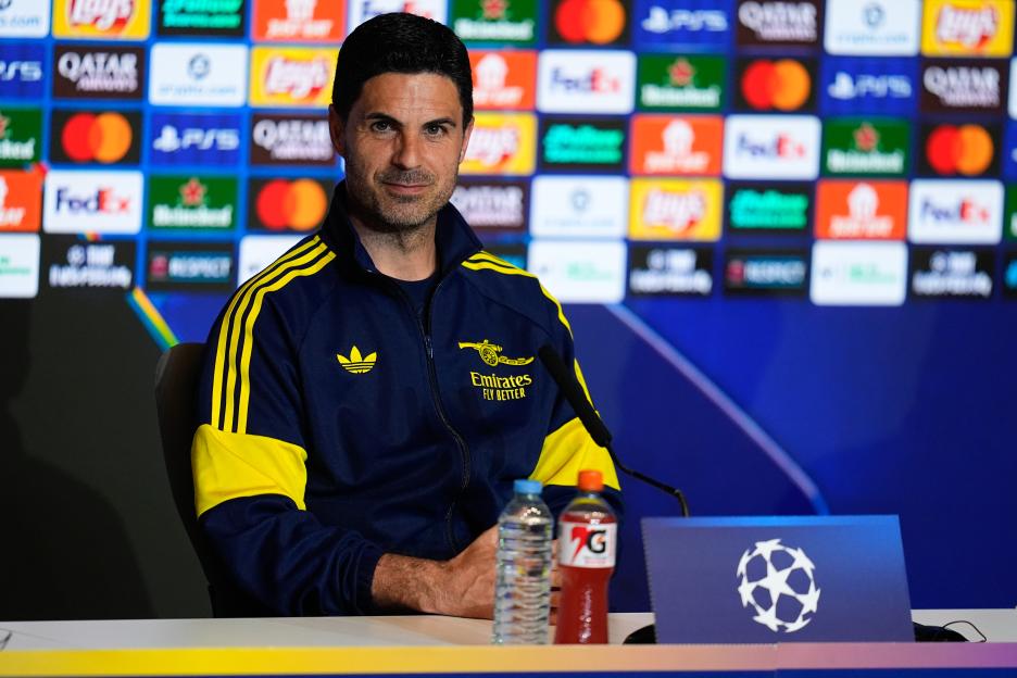 Mikel Arteta, head coach of Arsenal FC, sitting at a press conference.