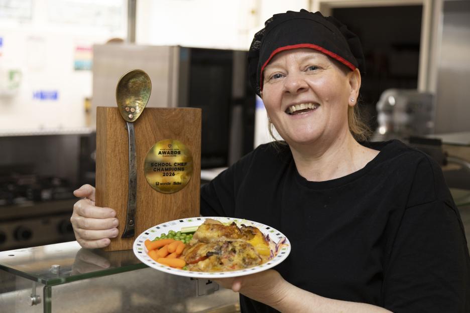 Tracey Nwabia, winner of School Chef of the Year 2026, holding a plate of food and her award.