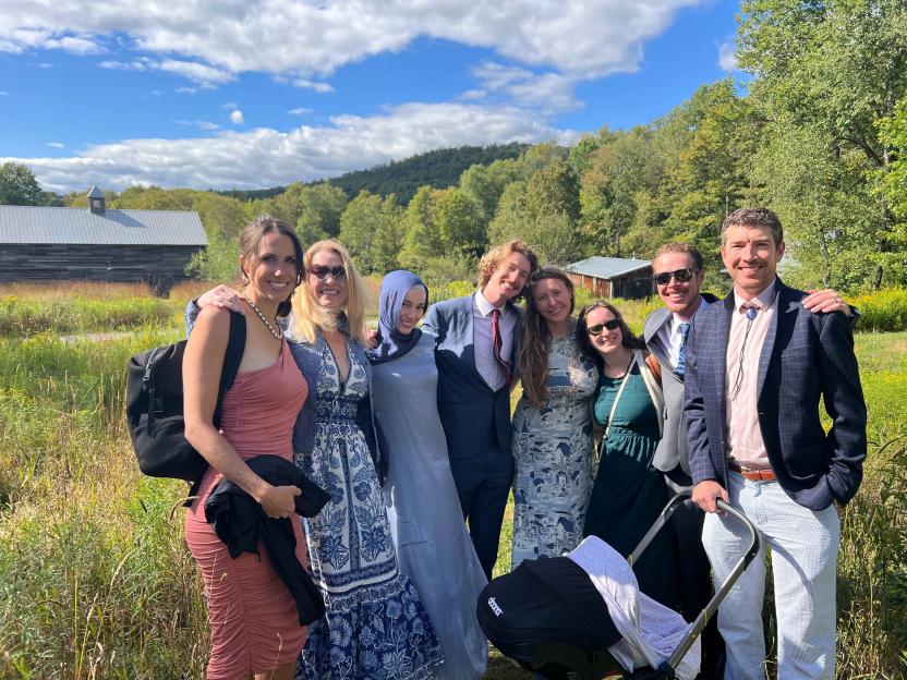 Eileen McGill Fox (second from left) with her children and their spouses, all smiling and standing outdoors.