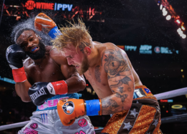 two boxers are fighting in front of a showtime sign