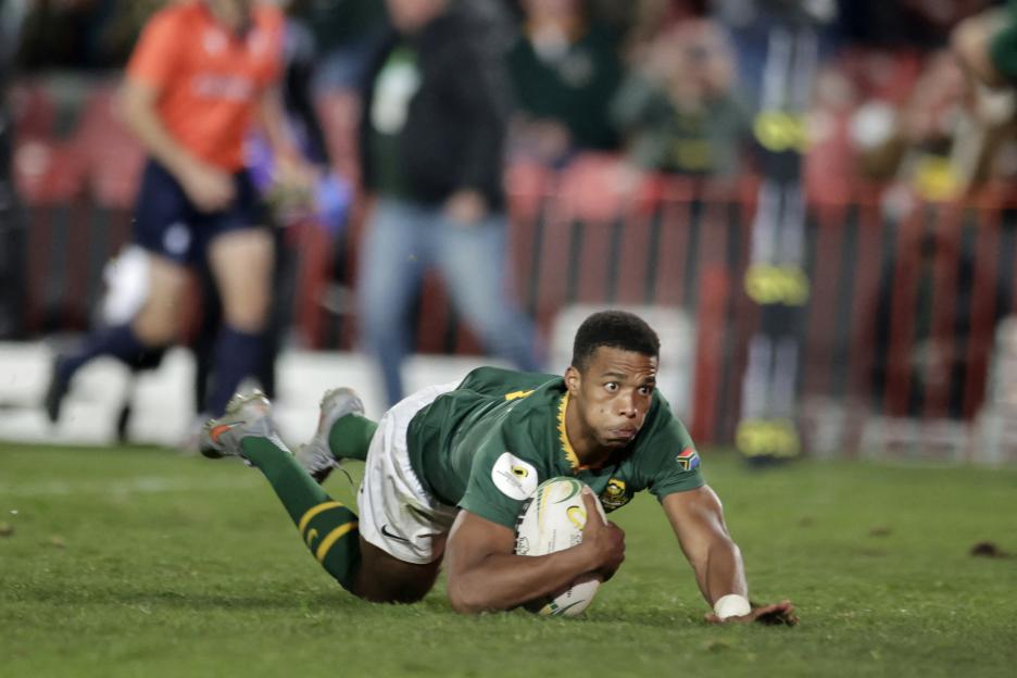 South Africa's scrum-half Grant Williams scores a try during a rugby match.