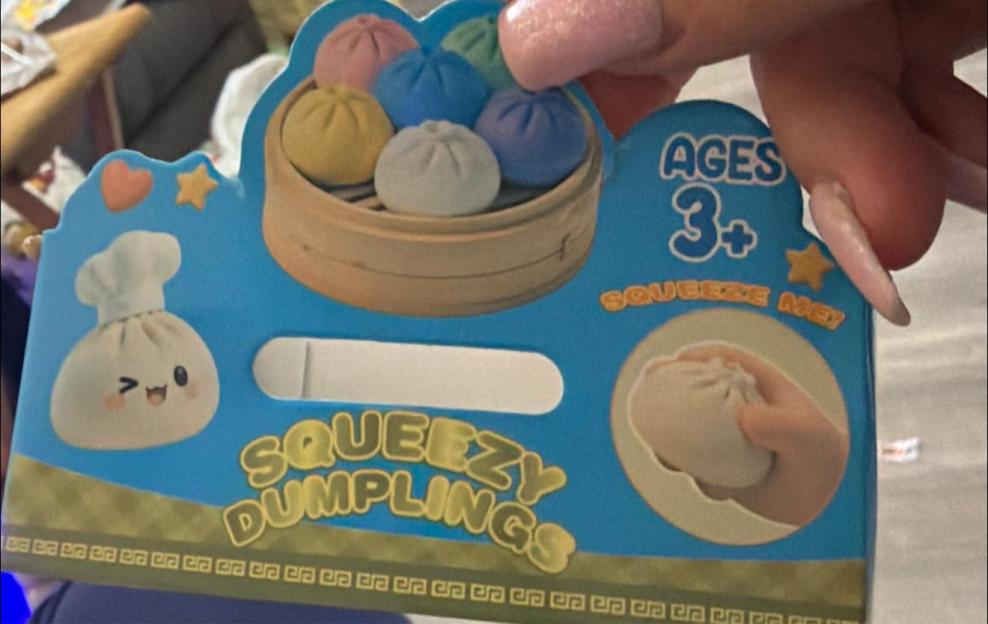 Packaging for "Squeezy Dumplings" toys, featuring colorful dumpling-shaped stress balls.